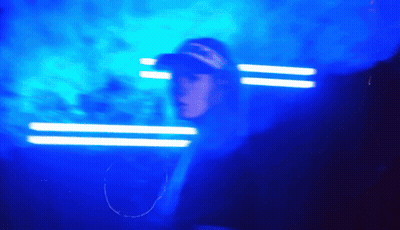 Man In Overalls And Mask In Crowd With VT Hats GIF
