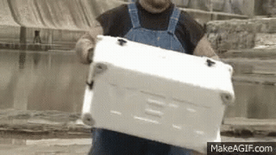 Man In Overalls Carrying White Cooler GIF