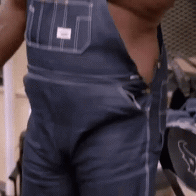 Man in Overalls Standing Shirtless