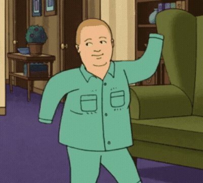 Man In Pajamas Standing Next To Green Chair GIF