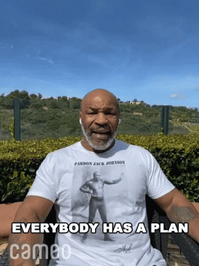 Man In Pardon Jack Johnson T-Shirt Says Everybody Has A Plan GIF