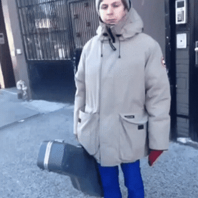 Man In Parka Holding Black Case GIF