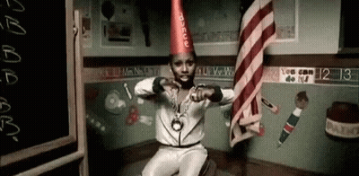 Man In Party Hat And Necklace Sitting In Classroom GIF