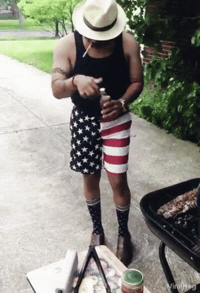 Man In Patriotic Shorts And Socks Smoking Cigarette GIF