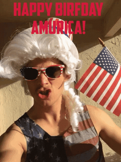 Man In Patriotic Wig And Sunglasses Holding American Flag GIF