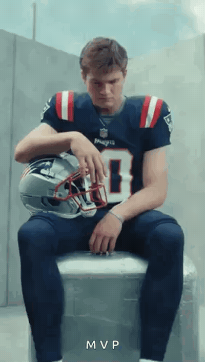 Man In Patriots Jersey On Cooler With Helmet GIF