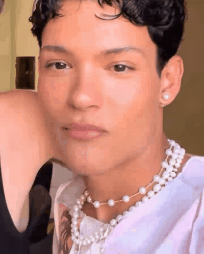 Man In Pearl Necklace And Earrings GIF