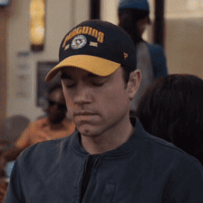 Man In Penguins Baseball Cap Looking Down GIF