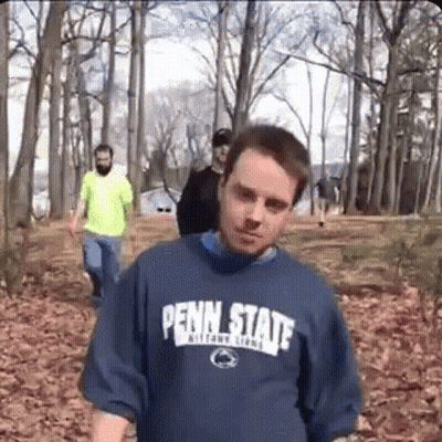 Man In Penn State Shirt Walking Through Forest GIF