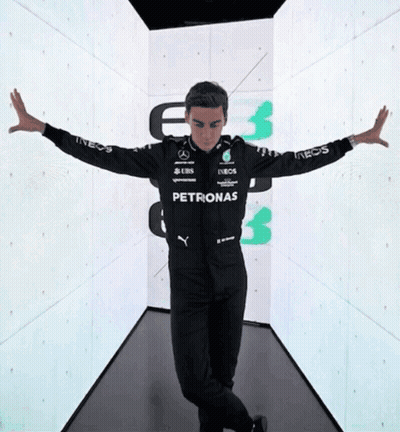 Man In Petronas Jacket In Hallway GIF