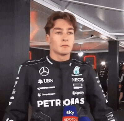 Man In Petronas Jacket With Microphone GIF