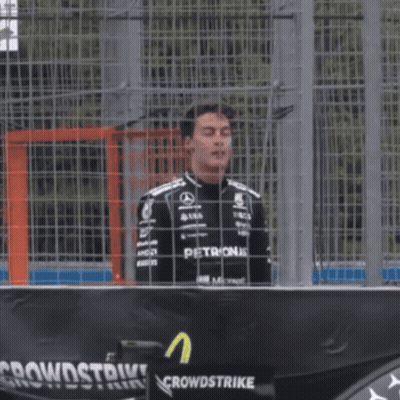 Man In Petronas Shirt At Crowdstrike Sign GIF