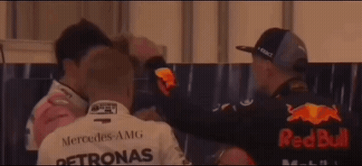 Man In Petronas Shirt Hugging Man In Red Bull Shirt GIF