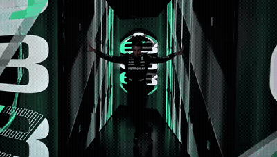 Man In Petronas Shirt Standing In Dark Tunnel GIF
