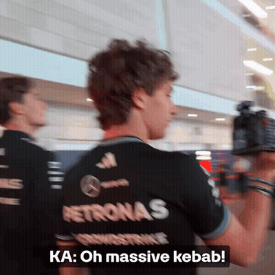 Man In Petronas Shirt Talking To Someone GIF