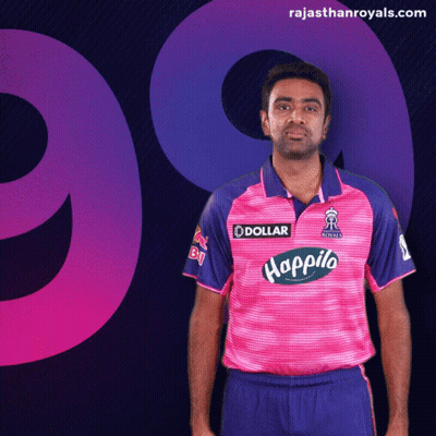 Man In Pink And Blue Shirt With Dollar Logo GIF