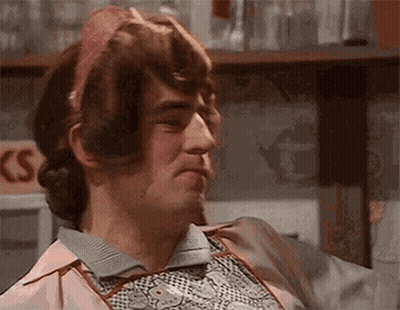 Man In Pink Apron And Headband Making Face GIF