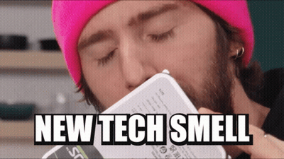 Man In Pink Beanie Smelling Box Saying New Tech Smell GIF