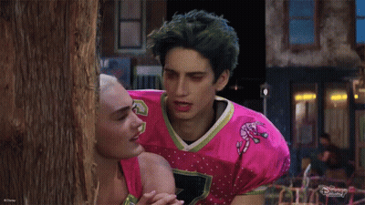 Man In Pink Candy Cane Jersey With Woman GIF