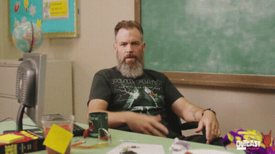 Man In Pink Floyd Shirt Sitting At Desk GIF