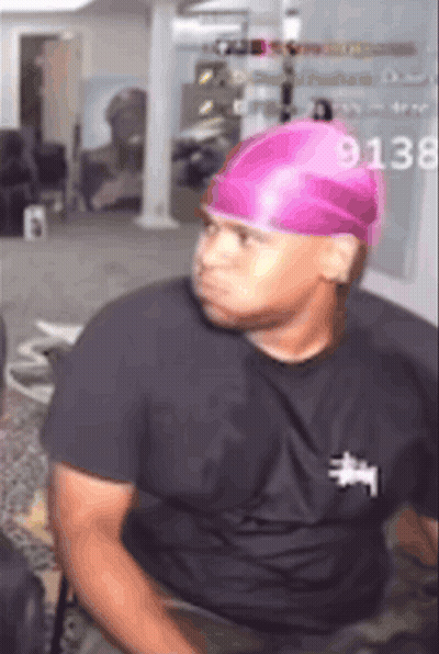 Man In Pink Hat And Black Shirt With 9138 GIF