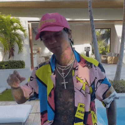 Man In Pink Hat And Colorful Shirt By Pool GIF