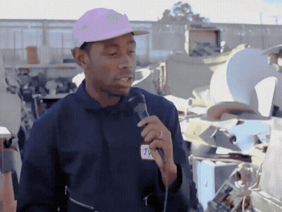 Man In Pink Hat And T-Mobile Jacket Holding Microphone GIF