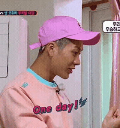 Man In Pink Hat, Pink Sweater By Window GIF