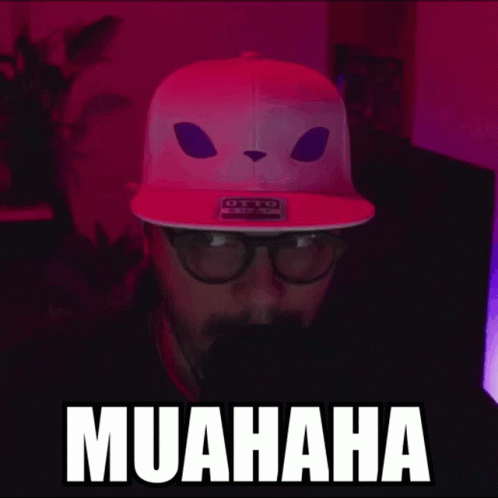 Man In Pink Hat With Cat Face Saying Muahaha GIF