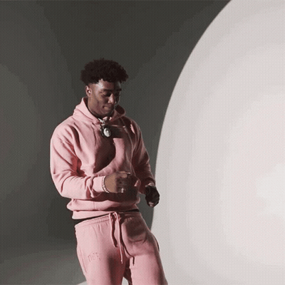 Man In Pink Hoodie And Pink Sweatpants Near White Sphere GIF