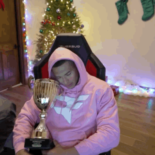 Man In Pink Hoodie Holding Trophy GIF