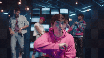 Man In Pink Hoodie Making Peace Sign Dancing GIF