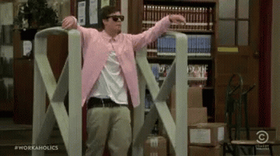 Man In Pink Jacket And Sunglasses By Giant Tape Dispenser GIF
