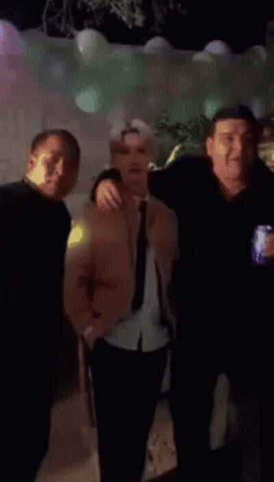 Man In Pink Jacket And Tie Next To Man In Black Shirt GIF