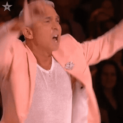 Man In Pink Jacket Arms In Air GIF