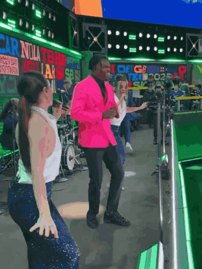 Man In Pink Jacket Dancing In Front Of Carolina Sign GIF