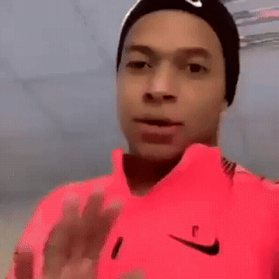 Man In Pink Nike Shirt And Black Nike Hat Making Funny Face GIF
