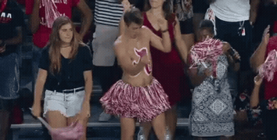 Man In Pink Pom Pom Skirt Dancing At Football Game GIF