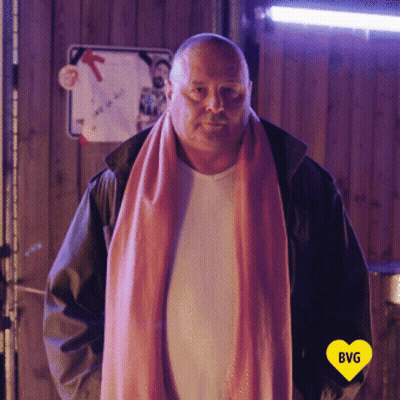 Man In Pink Scarf And White Shirt With Yellow Heart Saying BVG GIF