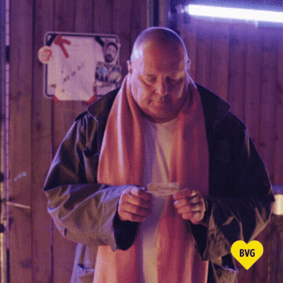 Man In Pink Scarf Holding BVG Heart Card GIF