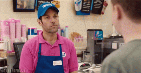 Man In Pink Shirt And Blue Apron Talking GIF