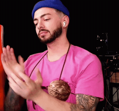 Man In Pink Shirt And Blue Beanie Clapping GIF