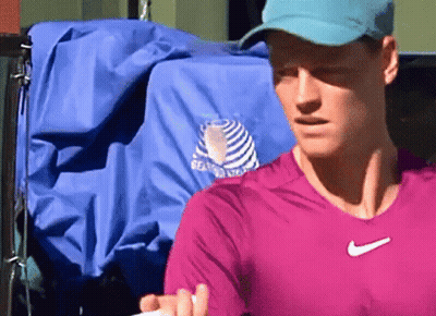 Man In Pink Shirt And Blue Hat Holding Tennis Racket GIF