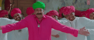 Man In Pink Shirt And Green Turban Dancing With Turbaned Men GIF