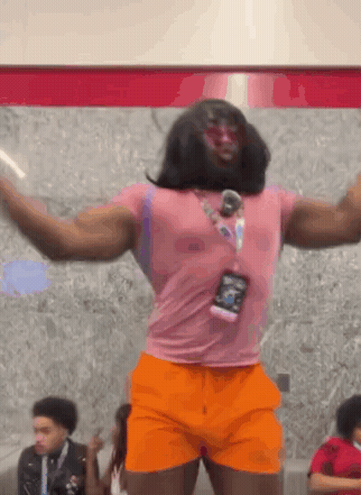 Man In Pink Shirt And Orange Shorts Dancing GIF