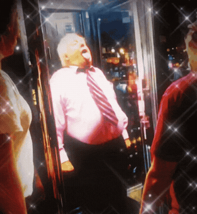 Man In Pink Shirt And Tie In Front Of Glass Door GIF