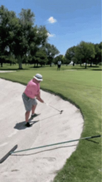 Man In Pink Shirt And White Hat Swinging Golf Club GIF