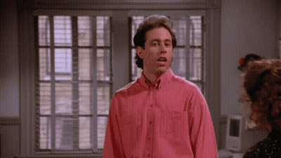 Man In Pink Shirt By Window With Blinds GIF