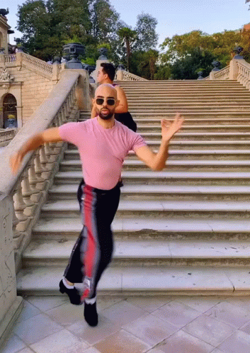 Man In Pink Shirt Dancing On Stairs GIF
