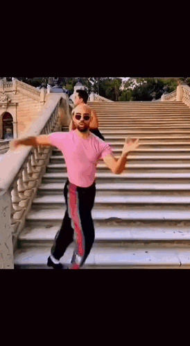 Man In Pink Shirt Dancing On Stairs GIF